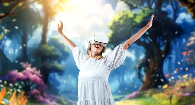 Caucasian girl enter metaverse while spread arms with relax at fantasy forest. Excited woman enjoy playing game by using VR goggles with magical world. Innovation technology concept. Contraption.