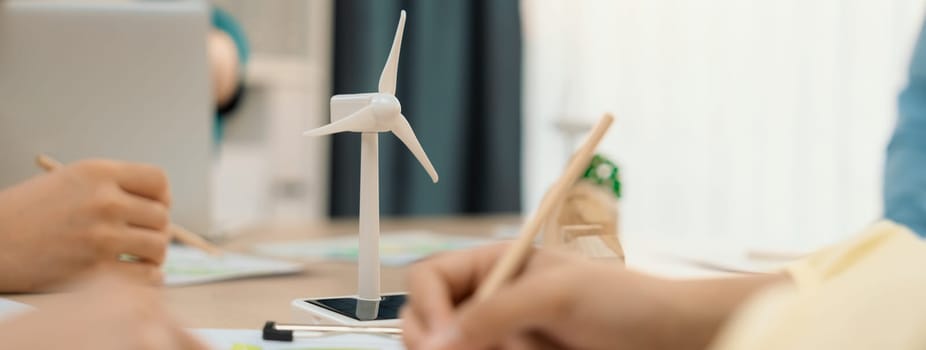 Green business meeting represented renewable energy. Skilled businesspeople discuss green business investment at table with environmental documents. Closeup. Focus on hand. Delineation.