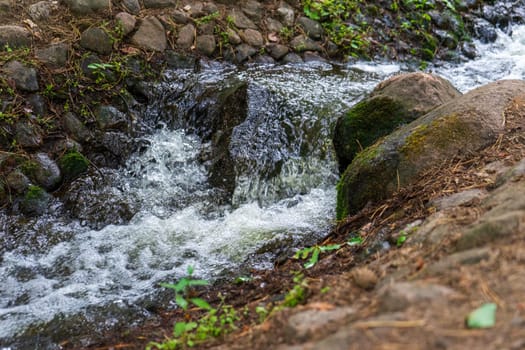 A small artificial waterfall on a stream in a city park. Minsk, Belarus