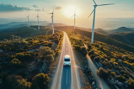 A van drives down a road lined with towering wind turbines.