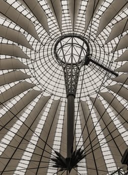 Berlin, Germany - Dec 19, 2023 - Glass ceiling of The Sony center is a building complex located at the Potsdamer Platz square. Construction of Futuristic rumbrella-like tent roof is Contemporary architecture in the district Tiergarten, Berlin-Mitte. Elliptical plaza, Space for text, Selective focus.