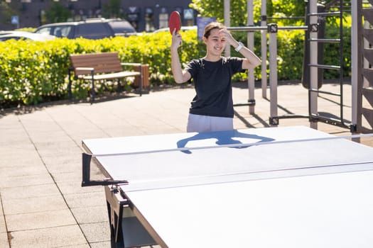 girl plays in table tennis outdoor. High quality photo