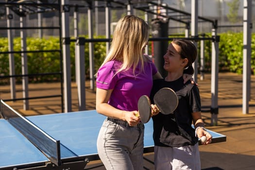 girl plays in table tennis outdoor. High quality photo