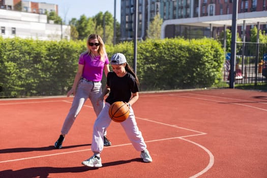 mother and daughter play basketball. High quality