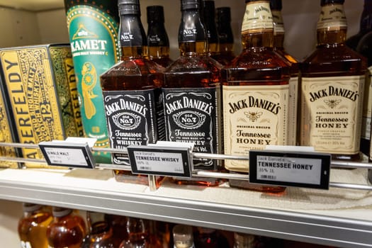 Various alcoholic drinks on a shelf in a store. Alcohol department in a supermarket. Jack Daniel's whiskey. Copenhagen, Denmark - May 15, 2024