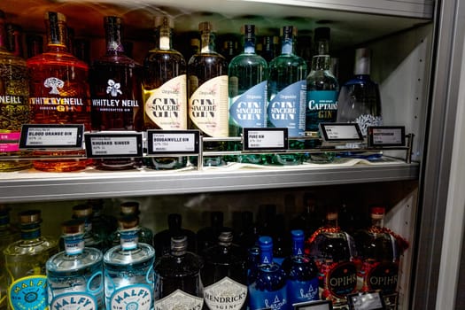 Various alcoholic drinks on a shelf in a store. Alcohol department in a supermarket. Copenhagen, Denmark - May 15, 2024