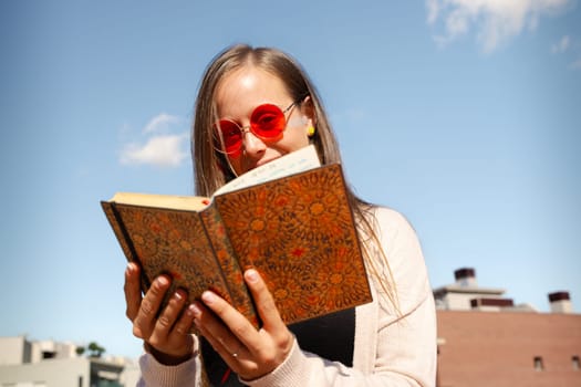 A concentrated Caucasian woman reads a book.