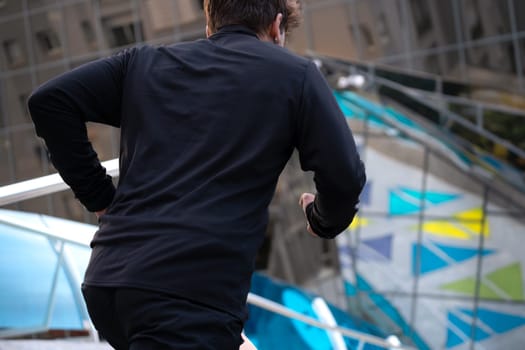 Man running down the stairs doing his daily cardio and warm-up exercise. Concept of Physical Activity