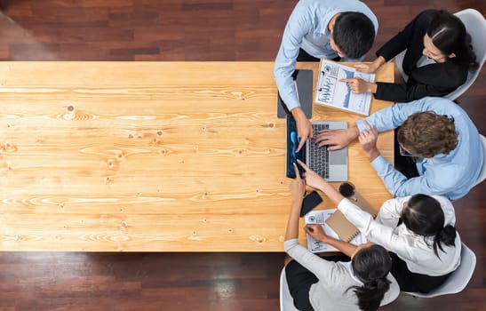 Panorama top view diverse group of business analyst team analyzing financial data report paper on meeting table. Chart and graph dashboard by business intelligence analysis. Meticulous