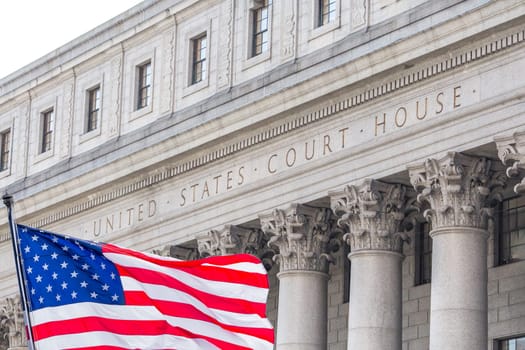 USA national flag waving in the wind in front of United States Court House in New York, USA