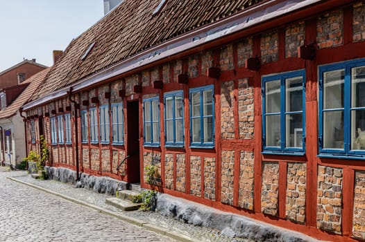 An ancient red brick building on a sunny day against a blue sky. Ystad, Sweden