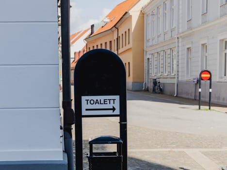 Sign in the city with the inscription in Swedish - toilet. High quality photo