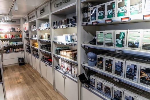 Shelves in a store with perfumes and underwear for men. Duty free shop on the ferry. Denmark - May 15, 2024.