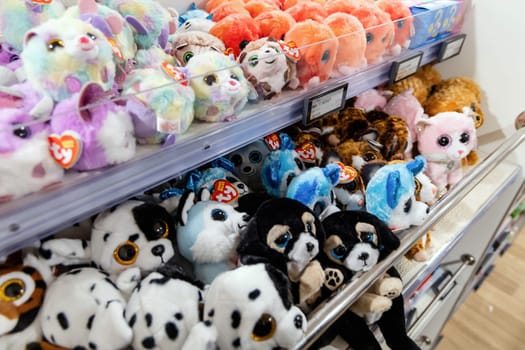 Various children soft toys on a shelf in a store. Copenhagen, Denmark - May 15, 2024.