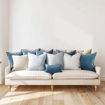 Living room with white walls, with blue and beige sofa cushions lying on a white sofa. Interior concept.