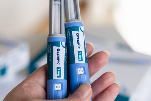 Hand holding Ozempic Insulin injection pen for diabetics. Denmark - March 25, 2024