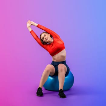 Full body length gaiety shot athletic and sporty young woman with fitness exercising ball in standing posture on isolated background. Healthy active and body care lifestyle.