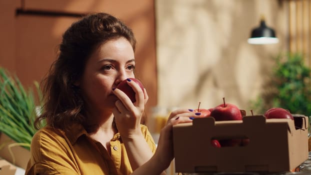 Vegan woman in zero waste eco supermarket feels dopamine rush while smelling apples. Client in local grocery shop has nostalgic bliss moment seeing farm grown fruits, remembering childhood, close up