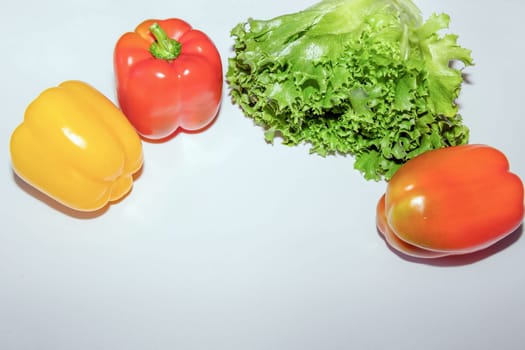 Sweet red and yellow pepper vegetables and green lettuce. Healthy lifestyle.