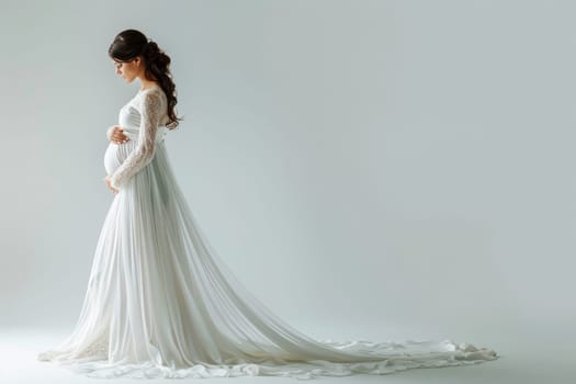 A pregnant woman stands in front of a white background wearing a white gown. The gown is long and flowing, and the woman is in a state of contemplation. Concept of serenity and contemplation