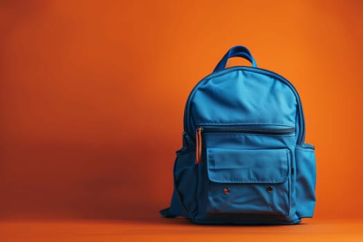 A blue backpack sits on a red background. The backpack is open and ready to be used. The orange straps on the backpack add a pop of color to the scene