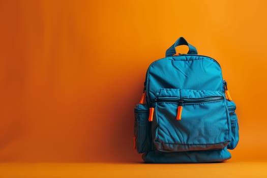 A blue backpack sits on a red background. The backpack is open and ready to be used. The orange straps on the backpack add a pop of color to the scene