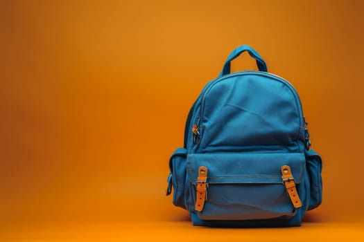 A blue backpack sits on a red background. The backpack is open and ready to be used. The orange straps on the backpack add a pop of color to the scene