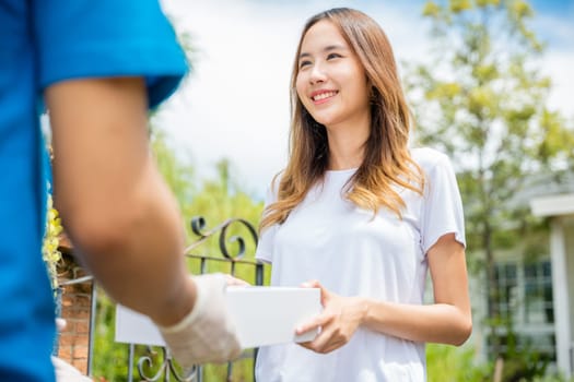 Delivery man give medicine drug store to patient female at front home, healthcare medicine online business, Asian woman sick she receive medication first aid pharmacy box hospital delivery service