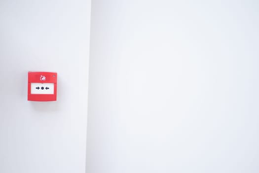 Red fire alarm button on wall