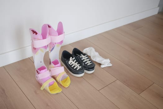 child legs orthosis and shoes on a wooden floor ,