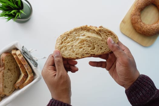 a slice of white bread with brad crumbs on hand .