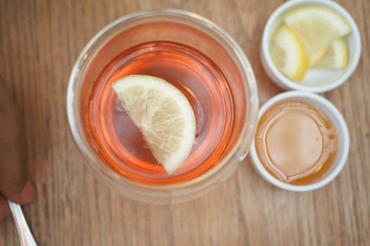 Top view of lemon tea pouring in a cup .