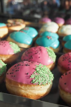 chocolate donuts display for sale at local store ,