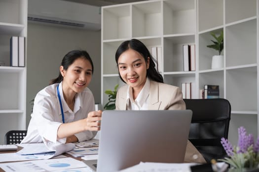 A team of business people who support each other's work Work consultants and employees discuss working on business documents together..