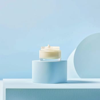 Cosmetic cream in a glass jar on a blue backdrop. Skin care concept. Background for beauty products