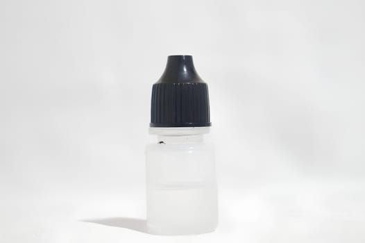 Small Bottle with Black Cap on White Background. High quality photo