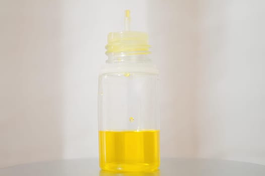 Bottle of Sunshine Yellow Liquid in a Yellow Bottle. High quality photo