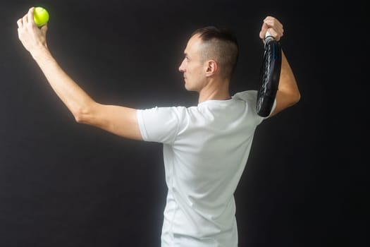 Padel Tennis Player with Racket in Hand. Paddle tennis, on a black background. High quality photo