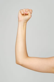 Young Woman Arm with Gesture close up on gray background