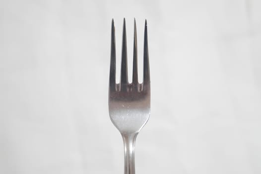 A fork is shown in a close up shot. High quality photo
