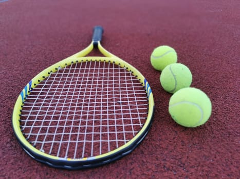 Tennis racket and ball on a hard tennis court. High quality photo