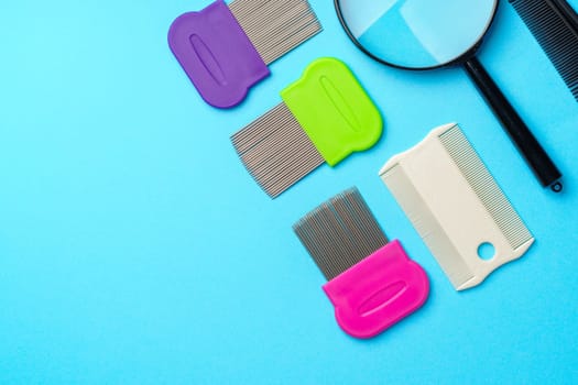 Comb for lice removing on blue background studio shot