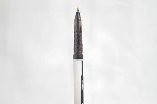 A pen with a black tip is sitting on a white background. High quality photo