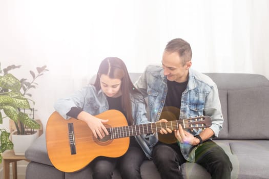 Guitar teacher teaching the little girl. High quality photo