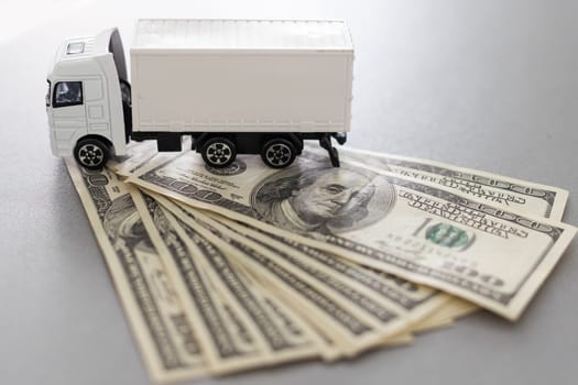 Toy car truck with money isolated on white background. High quality photo