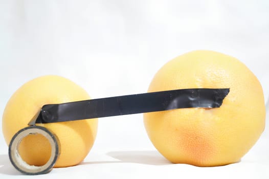 Grapefruits Connected with Electrical Tape. High quality photo