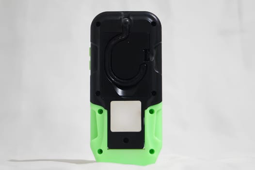 A green and black cell phone with a white background. High quality photo