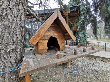 house in the forest for animals and birds. Wooden bird house in the summer park. on an tree stump. Old wooden feeder for birds on a tree, empty bird's feeder caring about wild birds in cold season. High quality photo