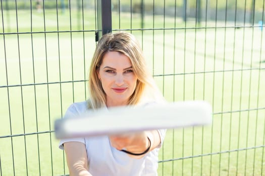 Sportive young girl with racquet playing padel in court. High quality photo