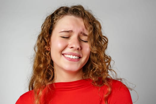 Young Woman With Curly Hair Expressing Concern Upset Sad